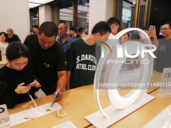 Visitors are shopping for a Huawei Mate60 mobile phone that supports Beidou satellite calls at the Huawei flagship store in Shanghai, China,...