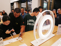 Visitors are shopping for a Huawei Mate60 mobile phone that supports Beidou satellite calls at the Huawei flagship store in Shanghai, China,...