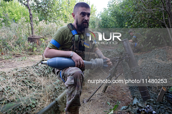 A serviceman of the 24th King Daniel of Galicia Separate Mechanized Brigade is firing a mortar at the positions of Russian troops near Chasi...