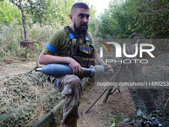 A serviceman of the 24th King Daniel of Galicia Separate Mechanized Brigade is firing a mortar at the positions of Russian troops near Chasi...