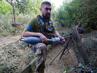 A serviceman of the 24th King Daniel of Galicia Separate Mechanized Brigade is firing a mortar at the positions of Russian troops near Chasi...