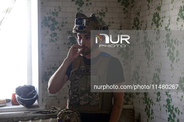 A serviceman of the 24th King Daniel of Galicia Separate Mechanized Brigade is smoking a cigarette during a break between combat missions ne...