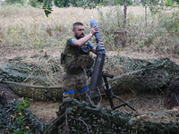 A serviceman of the 24th King Daniel of Galicia Separate Mechanized Brigade is loading a mortar while firing at the position of Russian troo...