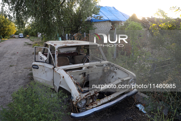 A destroyed civilian car is being left on the roadside in Kamianka village, Kharkiv region, Ukraine, on August 14, 2024, which is being dest...