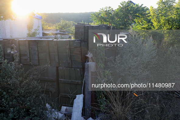 Abandoned Russian ammunition boxes are being stacked in the yard house in Kamianka village, Kharkiv region, which is being destroyed by Russ...