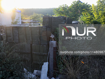 Abandoned Russian ammunition boxes are being stacked in the yard house in Kamianka village, Kharkiv region, which is being destroyed by Russ...