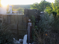 Abandoned Russian ammunition boxes are being stacked in the yard house in Kamianka village, Kharkiv region, which is being destroyed by Russ...