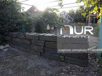 Abandoned Russian ammunition boxes are being stacked in the yard house in Kamianka village, Kharkiv region, which is being destroyed by Russ...