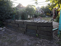 Abandoned Russian ammunition boxes are being stacked in the yard house in Kamianka village, Kharkiv region, which is being destroyed by Russ...