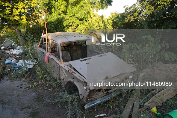 A destroyed civilian car is being left on the roadside in Kamianka village, Kharkiv region, Ukraine, on August 14, 2024, which is being dest...