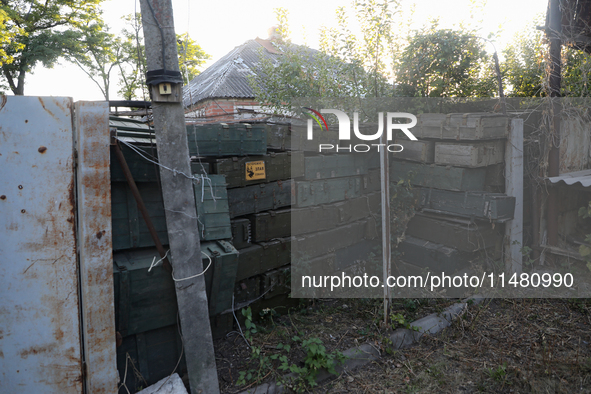 Abandoned Russian ammunition boxes are being stacked in the yard house in Kamianka village, Kharkiv region, which is being destroyed by Russ...