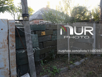 Abandoned Russian ammunition boxes are being stacked in the yard house in Kamianka village, Kharkiv region, which is being destroyed by Russ...