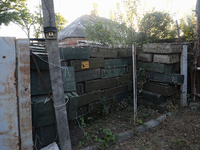 Abandoned Russian ammunition boxes are being stacked in the yard house in Kamianka village, Kharkiv region, which is being destroyed by Russ...