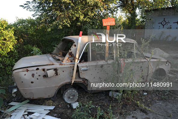 A destroyed civilian car is being left on the roadside in Kamianka village, Kharkiv region, Ukraine, on August 14, 2024, which is being dest...