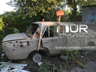 A destroyed civilian car is being left on the roadside in Kamianka village, Kharkiv region, Ukraine, on August 14, 2024, which is being dest...