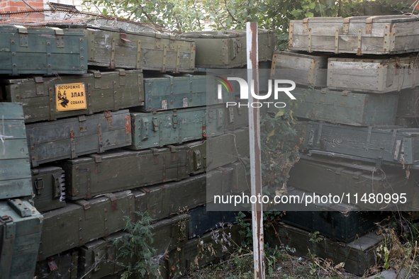 Abandoned Russian ammunition boxes are being stacked in the yard house in Kamianka village, Kharkiv region, which is being destroyed by Russ...