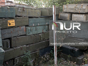 Abandoned Russian ammunition boxes are being stacked in the yard house in Kamianka village, Kharkiv region, which is being destroyed by Russ...