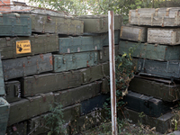 Abandoned Russian ammunition boxes are being stacked in the yard house in Kamianka village, Kharkiv region, which is being destroyed by Russ...