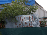 The sign is reading 'People Live Here' on the fence in Kamianka village, Kharkiv region, which is being destroyed by Russian troops during i...