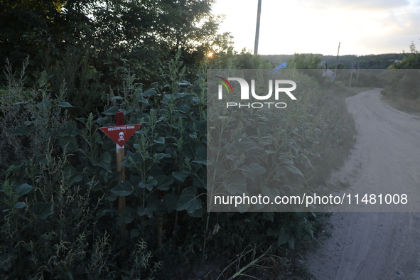 The 'Danger! Mines!' sign is standing in Kamianka village, Kharkiv region, Ukraine, on August 14, 2024, which was destroyed by Russian troop...