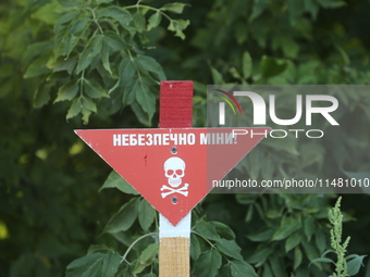 The 'Danger! Mines!' sign is standing in Kamianka village, Kharkiv region, Ukraine, on August 14, 2024, which was destroyed by Russian troop...