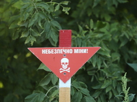 The 'Danger! Mines!' sign is standing in Kamianka village, Kharkiv region, Ukraine, on August 14, 2024, which was destroyed by Russian troop...