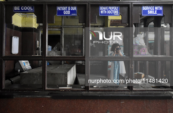 A junior doctor is taking photos with her mobile in the vandalized emergency ward at R.G. Kar Medical College and Hospital in Kolkata, India...