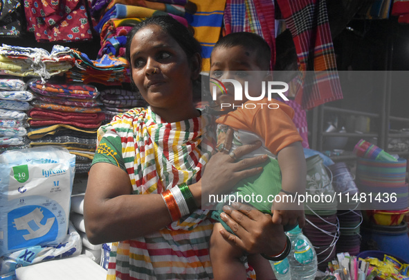 A woman is standing with her child outside of R G Kar Medical College in Kolkata, India, on August 15, 2024. 