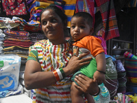 A woman is standing with her child outside of R G Kar Medical College in Kolkata, India, on August 15, 2024. (