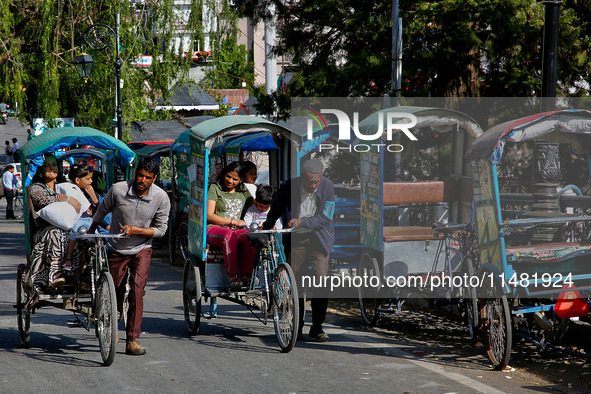 Rickshaw drivers are ferrying Indian tourists along the Mall Road in Mussoorie, Uttarakhand, India, on April 18, 2024. 