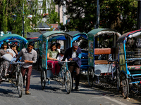 Rickshaw drivers are ferrying Indian tourists along the Mall Road in Mussoorie, Uttarakhand, India, on April 18, 2024. (