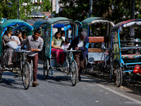 Rickshaw drivers are ferrying Indian tourists along the Mall Road in Mussoorie, Uttarakhand, India, on April 18, 2024. (