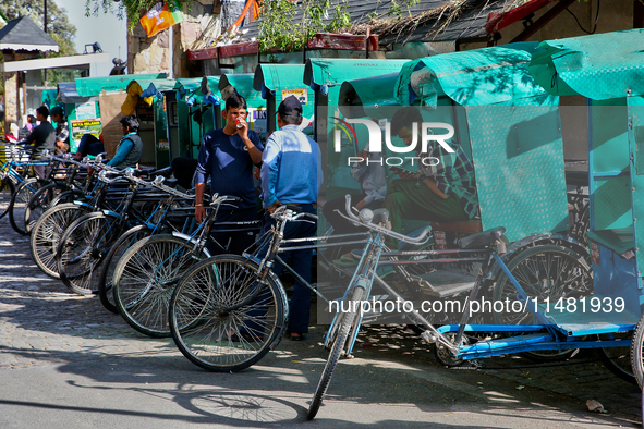 Rickshaw drivers are waiting for tourists to hire them along the Mall Road in Mussoorie, Uttarakhand, India, on April 18, 2024. 