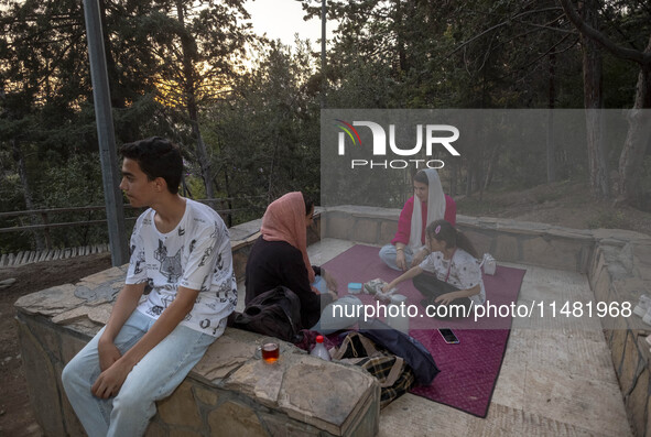 An Iranian family is camping at a park in central Tehran, Iran, on August 15, 2024. 