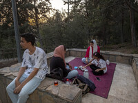 An Iranian family is camping at a park in central Tehran, Iran, on August 15, 2024. (