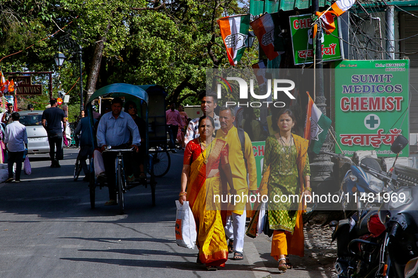 Indian tourists are walking along the Mall Road in Mussoorie, Uttarakhand, India, on April 18, 2024. 