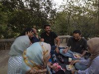 Iranian youths are celebrating a birthday while camping at a park in central Tehran, Iran, on August 15, 2024. (