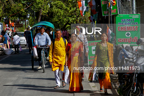 Indian tourists are walking along the Mall Road in Mussoorie, Uttarakhand, India, on April 18, 2024. 