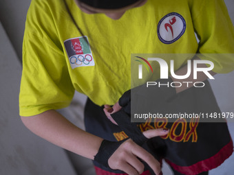 An Afghan refugee kickboxer is preparing to participate in an exercise session at a park in central Tehran, Iran, on August 15, 2024. (