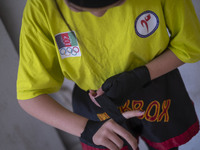 An Afghan refugee kickboxer is preparing to participate in an exercise session at a park in central Tehran, Iran, on August 15, 2024. (