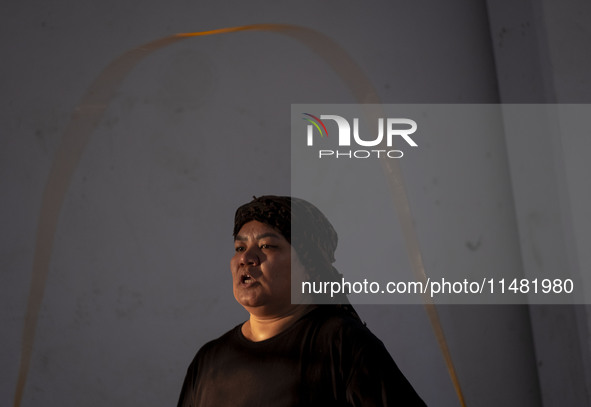 An Afghan refugee kickboxer is participating in an exercise session at a park in central Tehran, Iran, on August 15, 2024. 