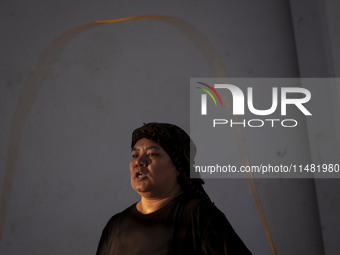 An Afghan refugee kickboxer is participating in an exercise session at a park in central Tehran, Iran, on August 15, 2024. (