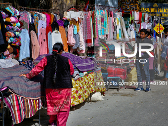 Members of the Tibetan community are selling clothing along the Mall Road in Mussoorie, Uttarakhand, India, on April 18, 2024. (