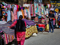 Members of the Tibetan community are selling clothing along the Mall Road in Mussoorie, Uttarakhand, India, on April 18, 2024. (