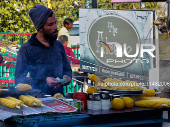 A man is selling grilled corn along the Mall Road in Mussoorie, Uttarakhand, India, on April 18, 2024. (