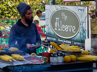 A man is selling grilled corn along the Mall Road in Mussoorie, Uttarakhand, India, on April 18, 2024. (