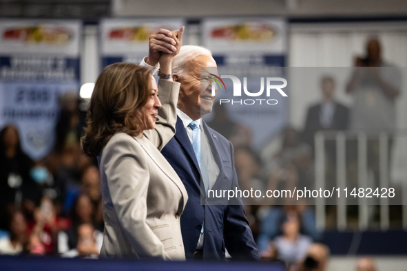 President Joe Biden join hands at the conclusion of an event announcing reduced Medicare prices for ten widely-used drugs, Upper Marlboro, M...