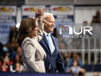 President Joe Biden join hands at the conclusion of an event announcing reduced Medicare prices for ten widely-used drugs, Upper Marlboro, M...