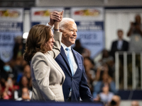 President Joe Biden join hands at the conclusion of an event announcing reduced Medicare prices for ten widely-used drugs, Upper Marlboro, M...