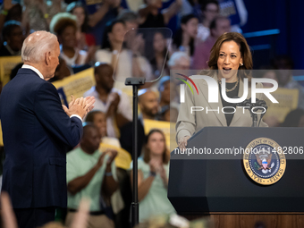 President Joe Biden and the audience cheer Vice President Kamala Harris during an event announcing reductions in Medicare prices for ten wid...